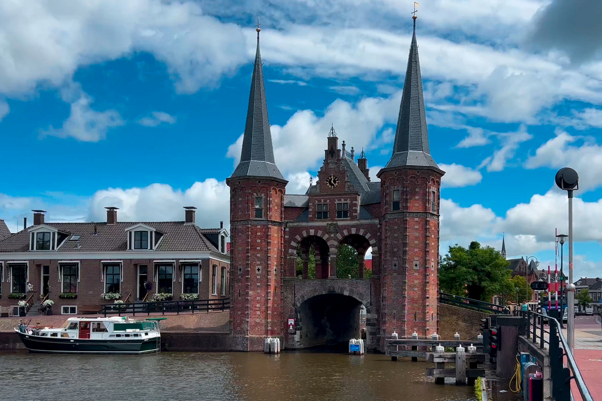 Traditional Dutch architecture of old houses and pier in historical center of Sneek, the Netherlands August 20, 2023